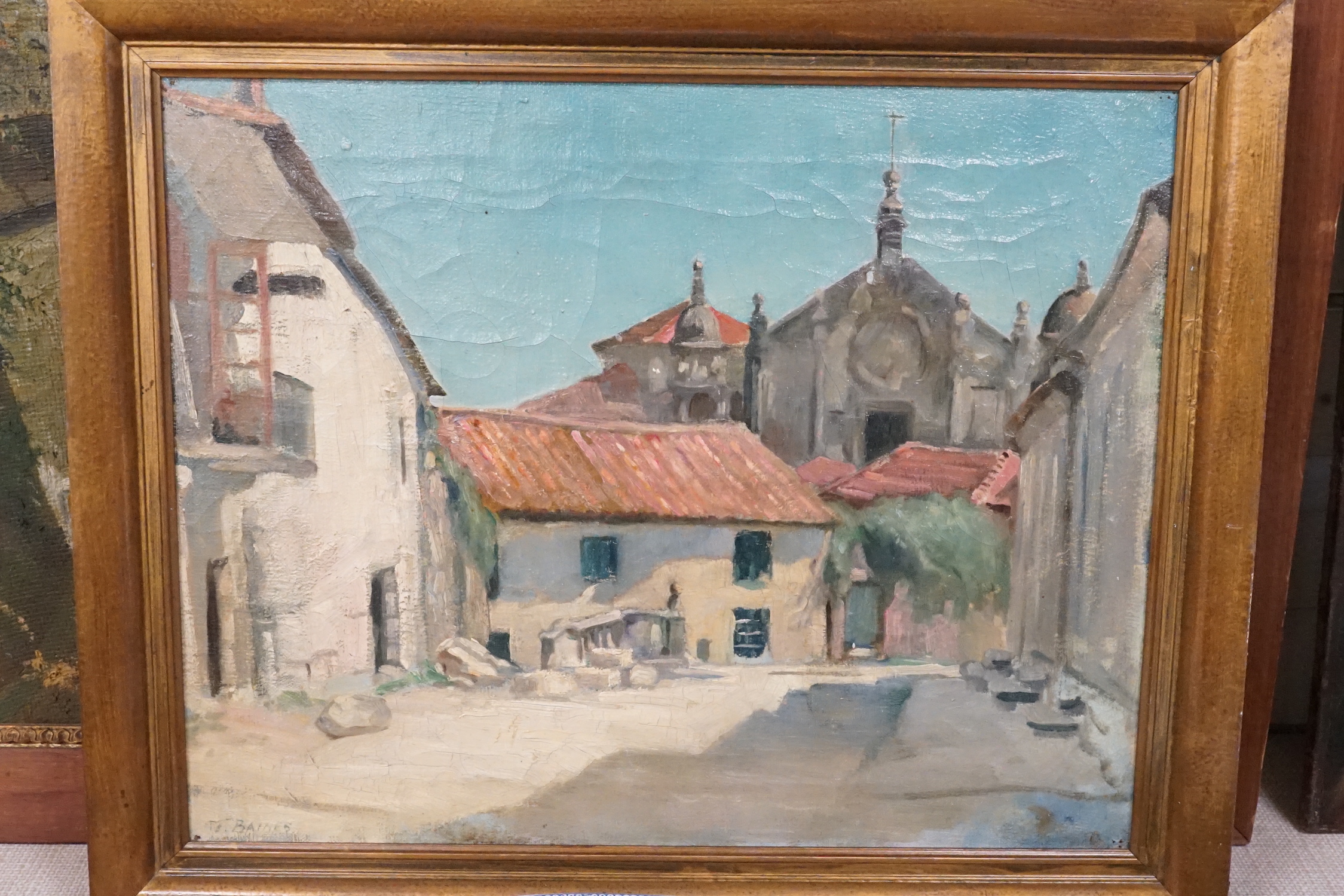 T. Baines, oil on canvas, Spanish town square, signed, 40 x 50cm, an oil on board of a cottage in winter, 24 x 33cm, and an Italian oil street scene, 52 x 67cm